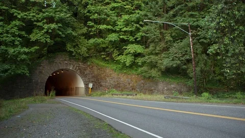 Handheld shot of female athlete jogging on road Stock Footage