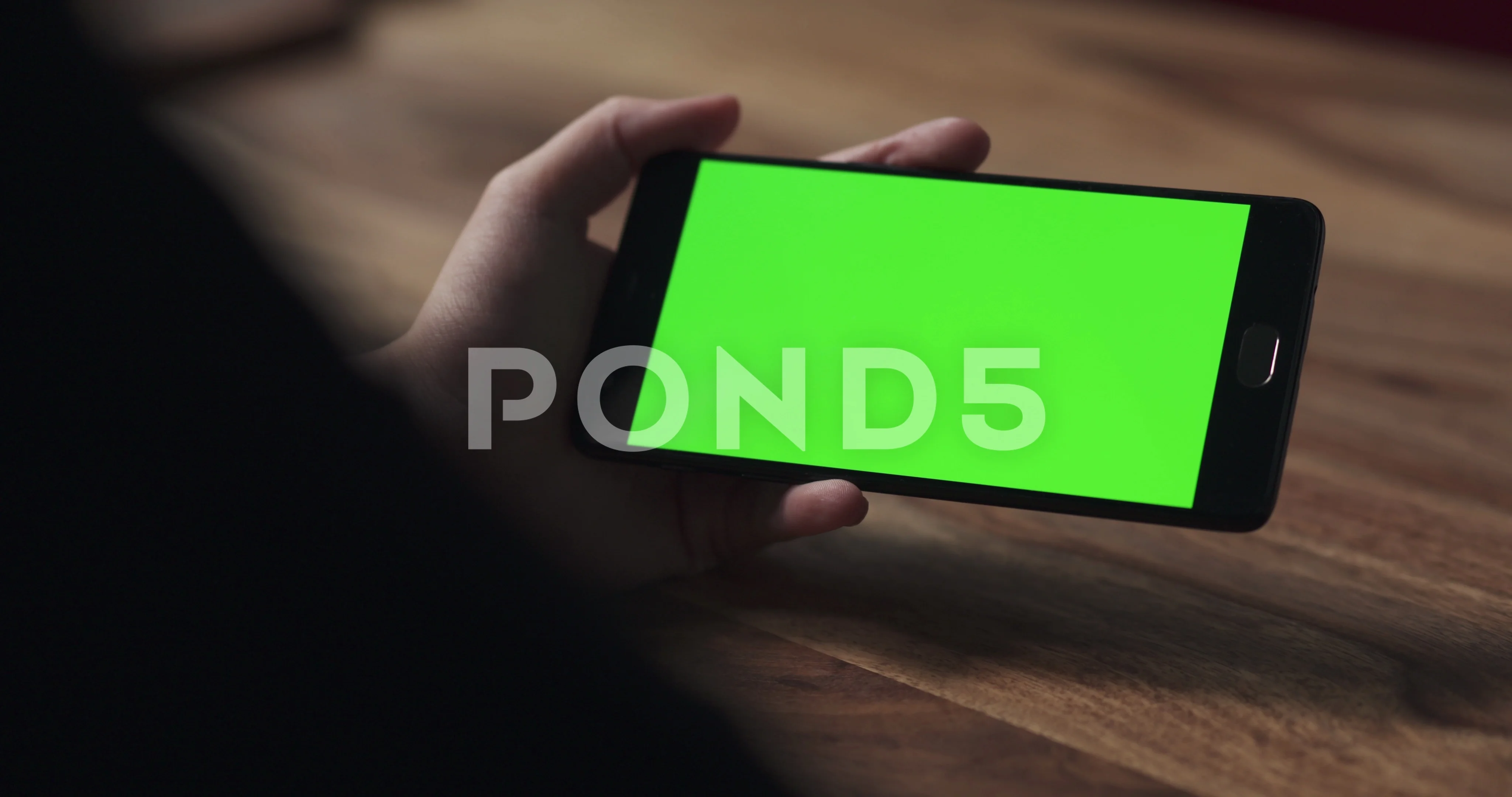 Handheld Shot Of Female Teen Holding Smartphone With Green Screen Over Wood Video 80061465 Handheld Shot Of Female Teen Holding Smartphone With Green Screen Over Wood Video 80061465