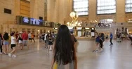 Handheld Shot Of Female Tourist Walking Towards Arrival Departure Board Stock Footage