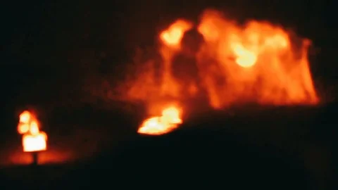 Handheld shot of fire dancer dancing on beach Video stock 122519108