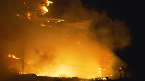 Handheld shot of a firefighter helicopter, trying to stop the Californian Stock Footage 119232216