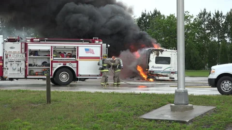 Handheld Shot Firemen Respond To Burning RV Stock Footage 48703121