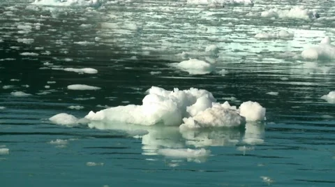 Handheld shot of floating ice in front of a calving glacier 库存影片 60004080