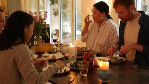 Handheld shot of four people talking and having dinner Stock Footage 114846677
