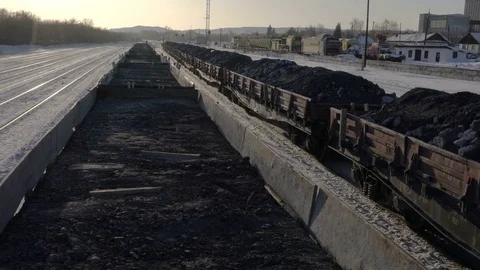Handheld shot of freight train with empty gondola cars moving around the station Stock Footage 75262747
