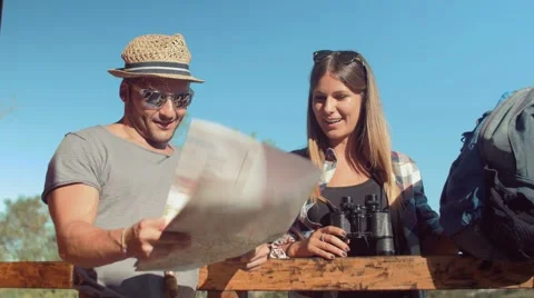Handheld shot of friends checking map outdoors Stock Footage 55033355
