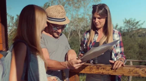 Handheld shot of friends checking map outdoors Video stock 55041015