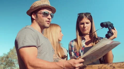 Handheld shot of friends checking map outdoors Video stock 55046810