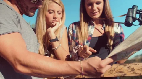 Handheld shot of friends checking map outdoors Stock Footage 55049440