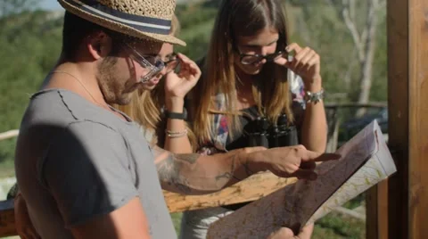 Handheld shot of friends checking map outdoors Vidéo 55049552
