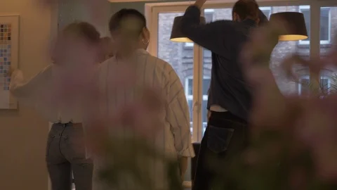 Handheld shot of friends dancing in front of window in library Vídeo Stock 114842789