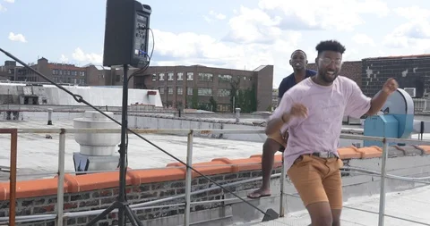 Handheld shot of friends dancing while young man taking selfie on smart phone Video stock 120153508