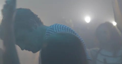 Handheld shot of friends dancing while holding illuminated mobile phones Stock Footage 120156827