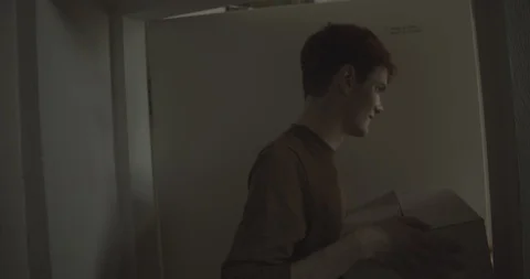Handheld shot of friends holding boxes of appliances open door of new home Stock Footage 120422136