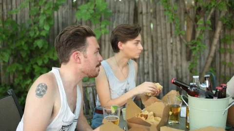 Handheld shot of friends talking with each other while having food Stock Footage 114862216