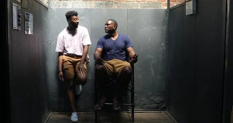 Handheld shot of friends talking while relaxing against wall Video stock 120153575