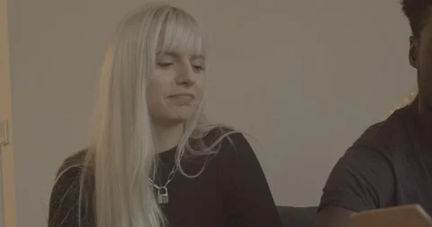 Handheld shot of friends talking while unpacking boxes Stock Footage 120422520