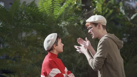 Handheld shot of friends talking while standing by tree Stock Footage 120422602