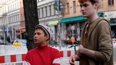Handheld shot of friends talking while standing outdoors Stock Footage 120423236