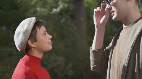 Handheld shot of friends talking while standing by tree Stock Footage 120423889