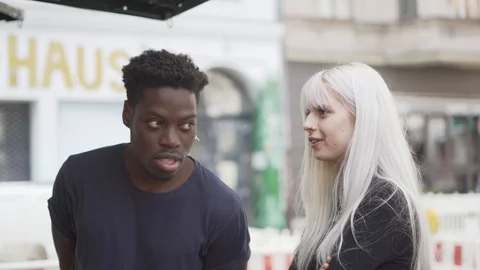 Handheld shot of friends talking while standing outdoors Stock Footage 120424509