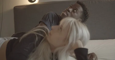 Handheld shot of friends talking while lying in bed Stock Footage 120425878