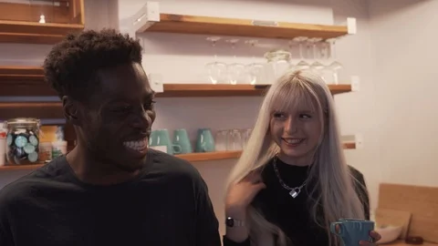 Handheld shot of friends talking while standing by kitchen counter Stock Footage 120426571