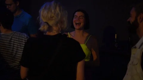 Handheld shot of group of friends having fun at the nightclub Stock Footage 114877837