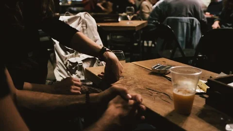 Handheld shot of group of friends having drinks in the bar Stock Footage 122397958