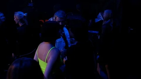 Handheld shot of group of people dancing and talking to each other Video stock 114886120