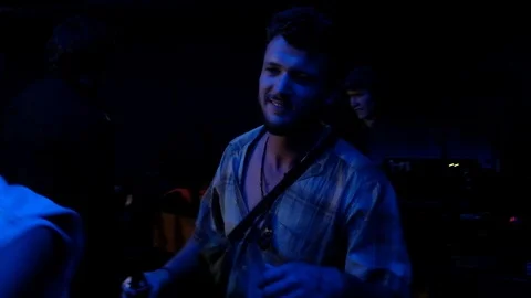 Handheld shot of group of people dancing and drinking in the club Video stock 114886130