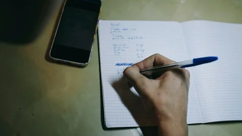 Handheld shot of hands of boy doing math homework at desk Stock Footage 122515204