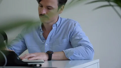 Handheld shot of handsome executive making notes in planner Stock-Footage 114872921