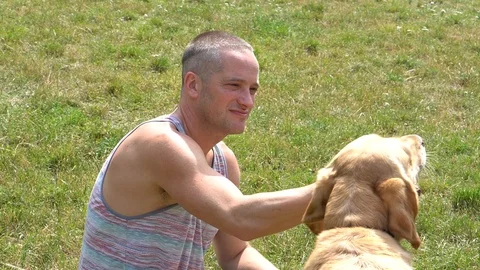 Handheld shot of handsome man playing with pet dog on sunny day 스톡 동영상 114849999