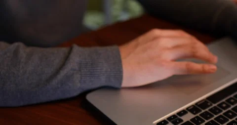 Handheld shot of happy couple talking while using laptop in living room Stock Footage 119753473