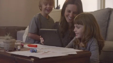 Handheld shot of happy mother with children video calling over tablet computer Stock Footage