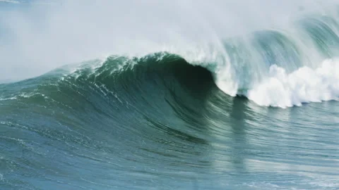 Handheld shot of huge ocean waves swimming towards seashore and foaming up Stock Footage 155789746