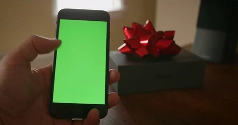 Handheld shot of iPhone 8 being used by swiping next to an apple box with a red Video stock 82853477