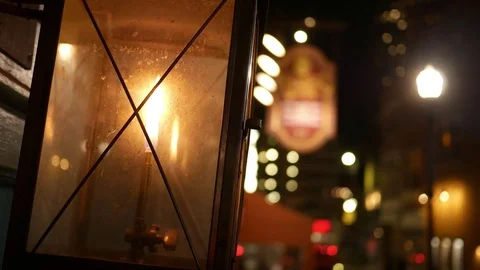 Handheld shot of Lantern outside store window in urban downtown city at night Video stock 83016358