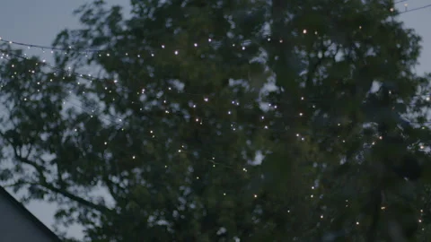 Handheld shot of a light string placed outside a house, making star Video stock 255269008