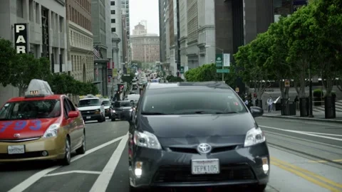 Handheld shot looking down market street in San Francisco with Trolley Stock Footage 145886834
