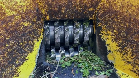 A handheld shot of a machine is a grinding tree. Video stock 132346498