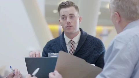 Handheld shot of male doctor explaining coworkers in meeting at hospital Stock Footage