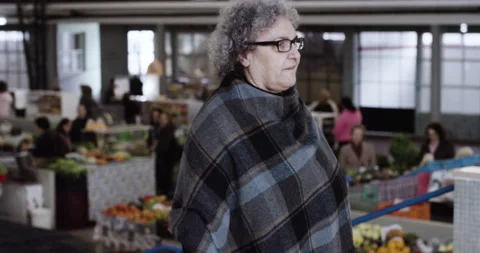 Handheld shot of Mama Celeste walking across restaurant and looking around Stock Footage 158693594