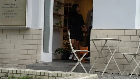 Handheld shot of man and women with shopping bag exits store 스톡 동영상 114849853