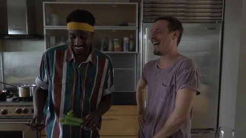 Handheld shot of man chopping while standing with boyfriend in slow motion 스톡 동영상 114878644