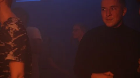 Handheld shot of man dancing with friend at nightclub Stock Footage 120156157