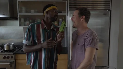 Handheld shot of man dancing while standing with boyfriend in slow motion Stock Footage 114878642