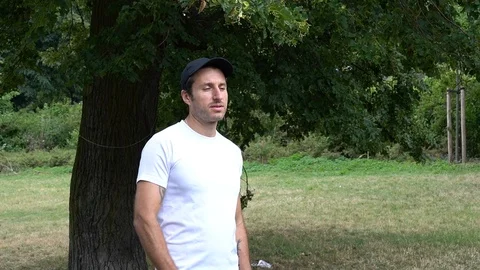 Handheld shot of man drinking water in the park Stock-Footage 114849312