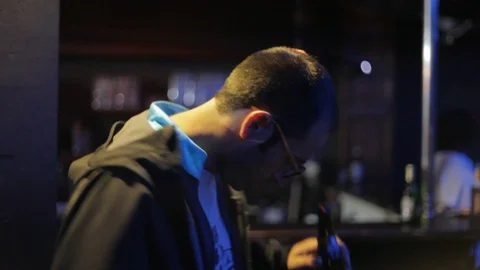 Handheld shot of man with glasses getting into the groove of the music Video stock 114847668